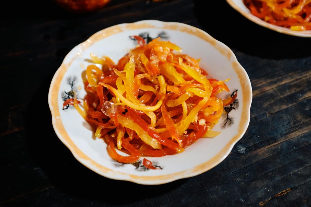Colorful pickled papaya served for Tet in Vietnam, showcasing traditional festive cuisine.