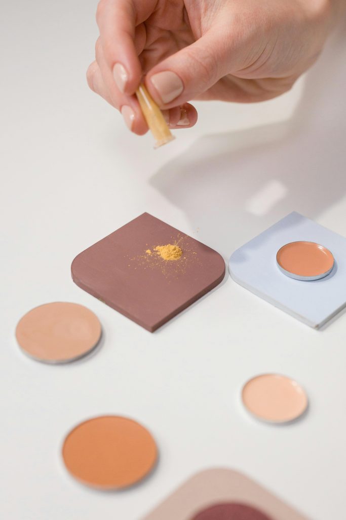 Close-up of eyeshadow application with brush on various makeup shades. Perfect for beauty and cosmetic themes.