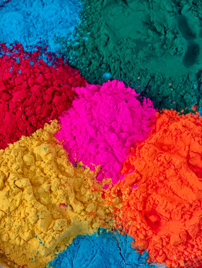 Colorful Holi powders display vibrant hues for festive celebration.